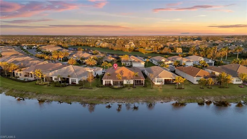 Aerial view at dusk with a residential view and a water view