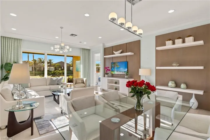 Dining area featuring ornamental molding, recessed lighting, visible vents, and an inviting chandelier