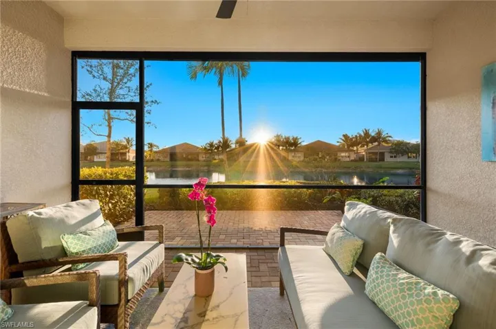 Sunroom / solarium featuring a water view