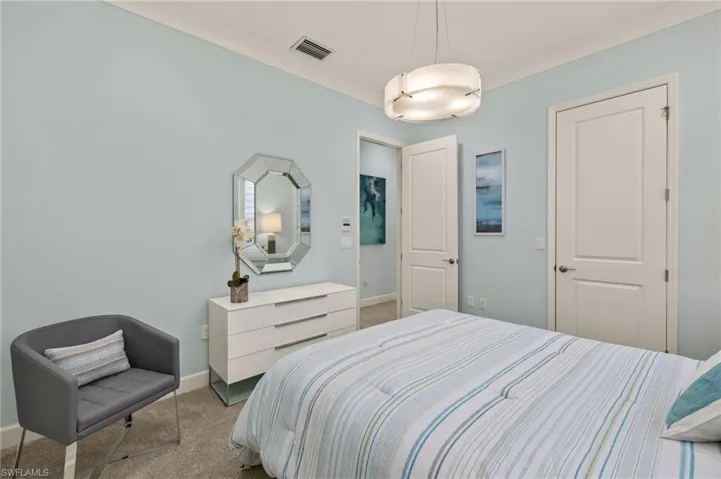 Bedroom with carpet, visible vents, and baseboards