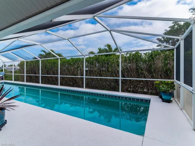 View of pool with a patio and a lanai