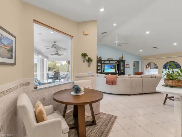 Tiled living room with tile walls and vaulted ceiling