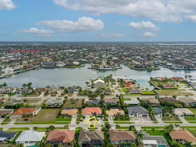 Birds eye view of property with a water view