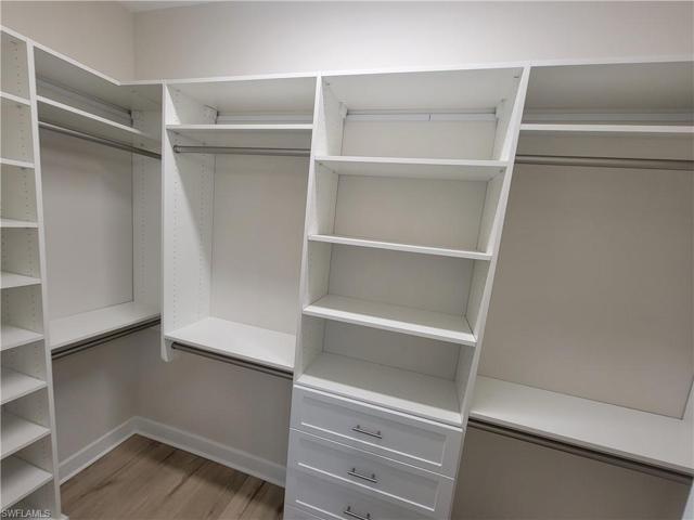 master closet has full built in hanging and storage