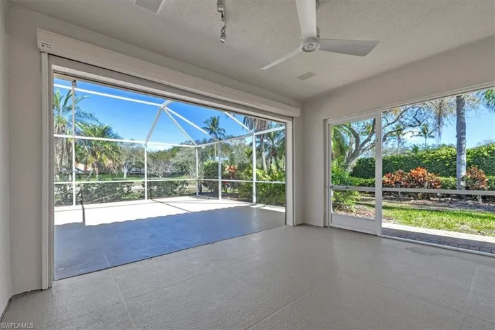 Covered lanai has lake and tropical landscape views.