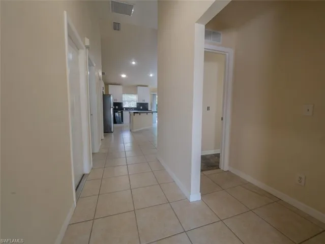 Hallway featuring light tile patterned flooring