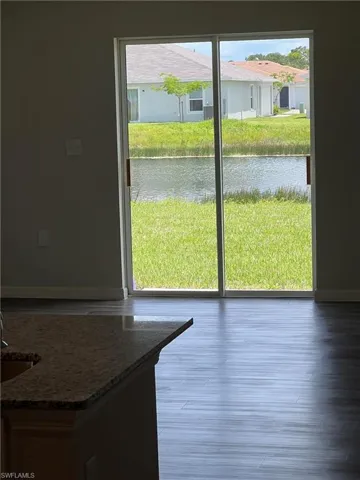 Entryway featuring wood finished floors, baseboards, and a water view