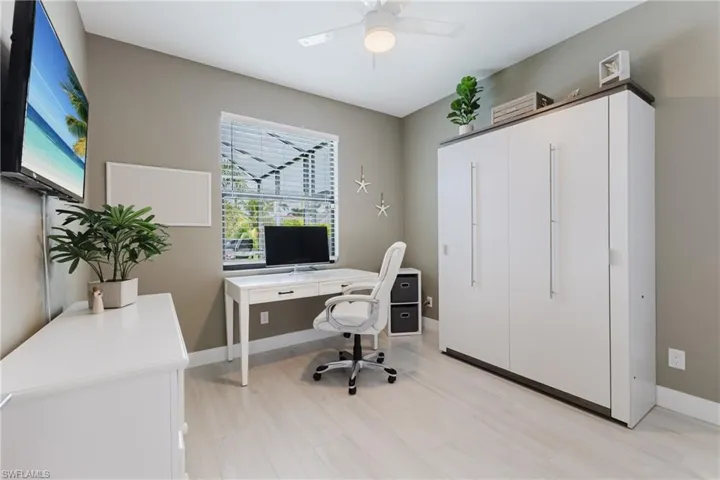 Office with ceiling fan and light wood-style floors
