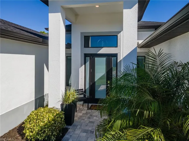 Entrance to property with stucco siding