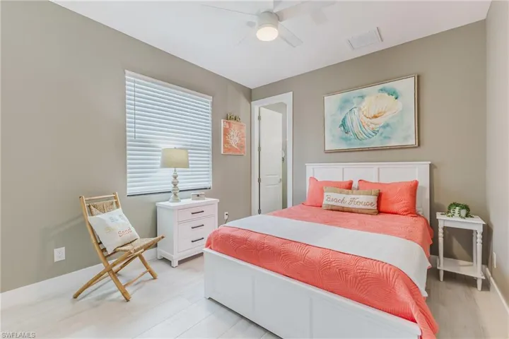 Bedroom with ceiling fan and light wood-style flooring