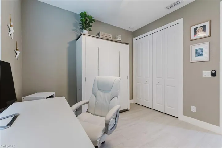 Office area featuring baseboards and light wood-type flooring