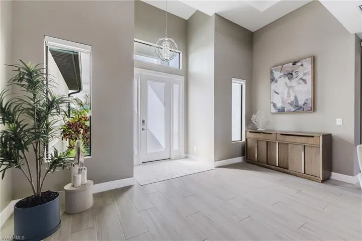 Foyer with wood finish floors and a chandelier