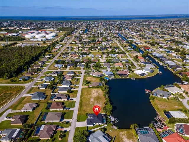 Aerial view of property's location with a large body of water and nearby suburban area