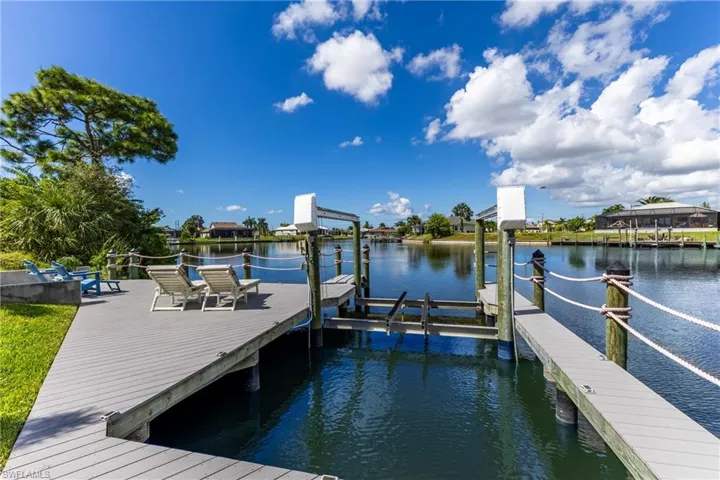 Dock area with boat lift and a water view
