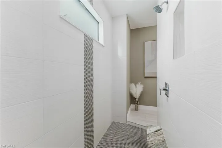 Full bath featuring tiled shower
