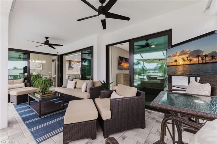 View of patio with a ceiling fan and an outdoor living space