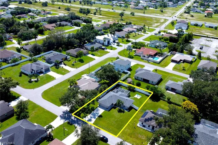 Aerial view of residential area with property parcel outlined