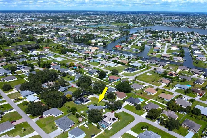 Aerial view of property's location featuring nearby suburban area and a large body of water