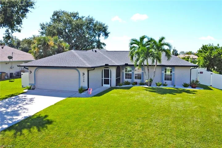 Single story home with driveway, stucco siding, a garage, and a shingled roof