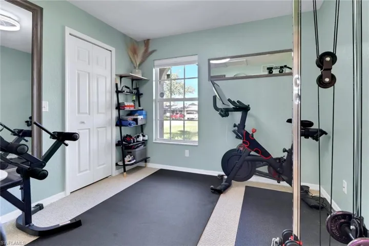 Exercise area featuring baseboards and carpet