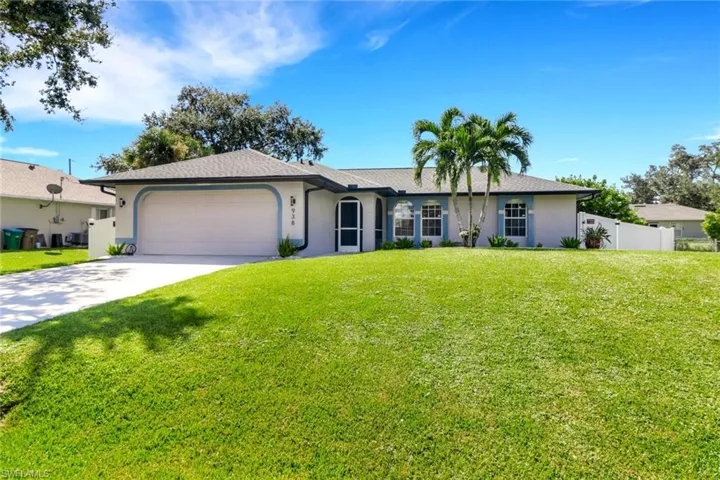 Single story home featuring an attached garage, driveway, and stucco siding