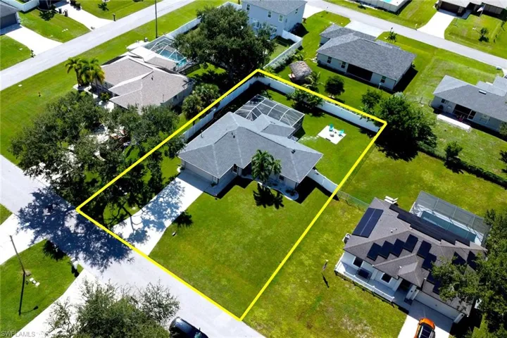 Aerial view of residential area with property boundaries highlighted