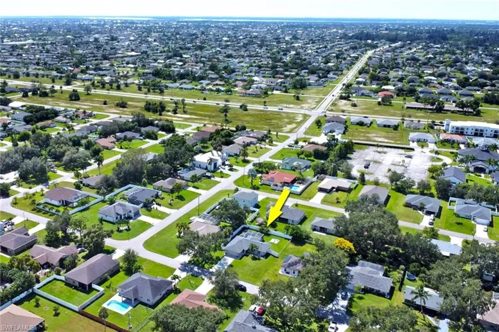 Aerial view of property's location featuring nearby suburban area