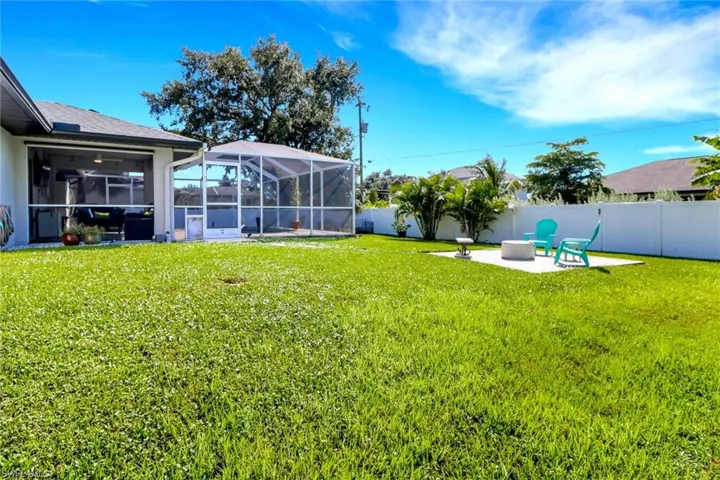 Fenced backyard with a lanai, a patio area, and a sunroom