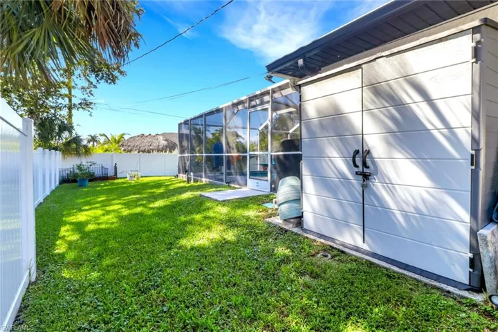 Fenced backyard with a sunroom and glass enclosure