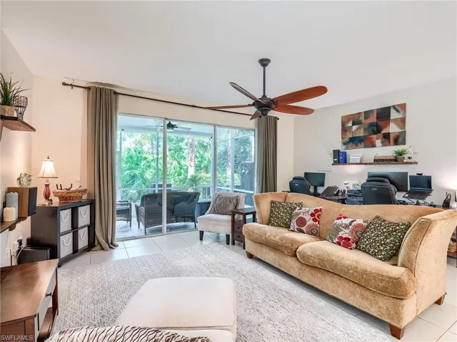 Tiled living room featuring ceiling fan