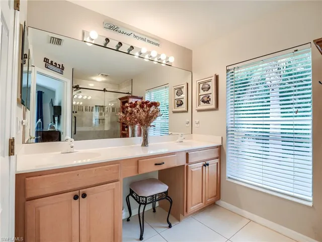 Bathroom featuring tile patterned floors and double sink vanity