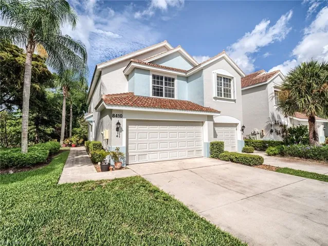 Mediterranean / spanish-style house featuring a garage and a front yard
