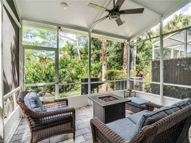 Sunroom / solarium with lofted ceiling and ceiling fan