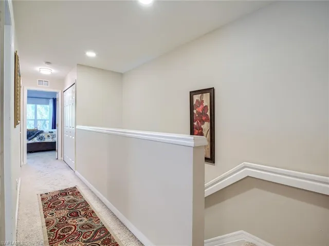 Hallway featuring carpet