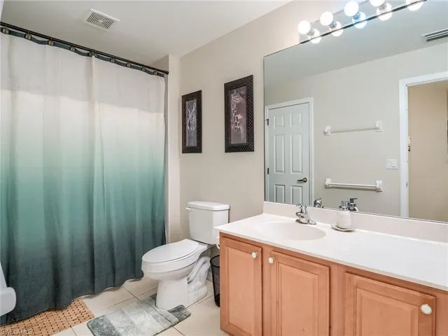 Bathroom with tile patterned floors, toilet, and vanity