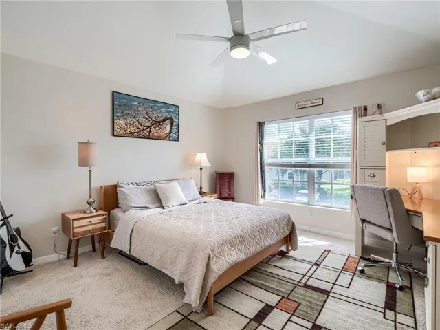 Bedroom with light carpet and ceiling fan
