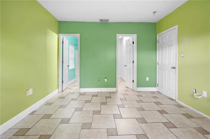 Primary bedroom with baseboards and visible vents