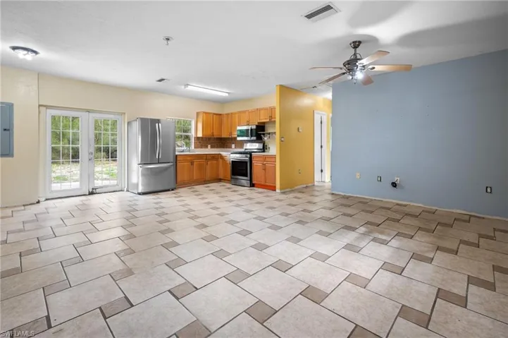 Kitchen featuring light countertops, appliances with stainless steel finishes