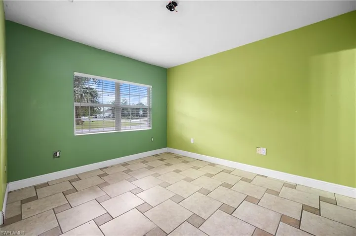 Unfurnished room with baseboards