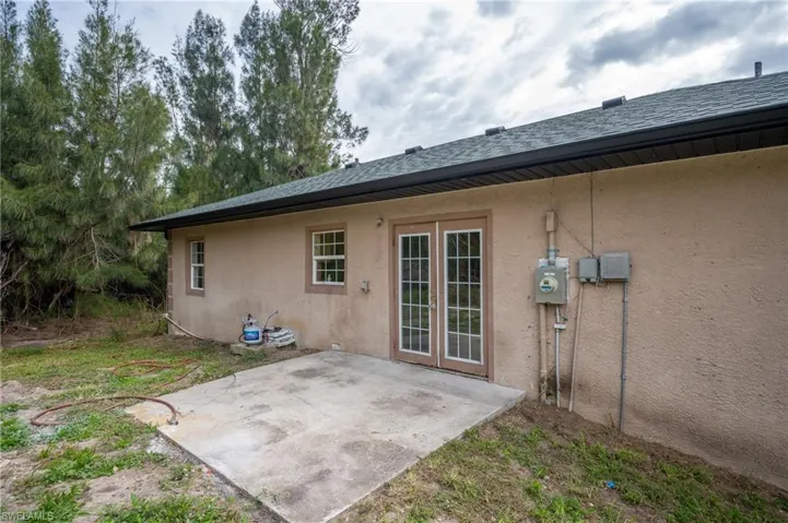 Rear view of property featuring stucco siding and a patio