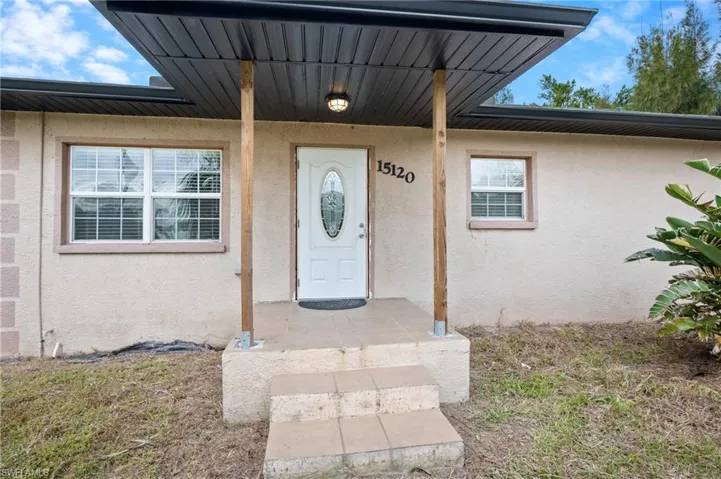 Doorway to property with stucco siding