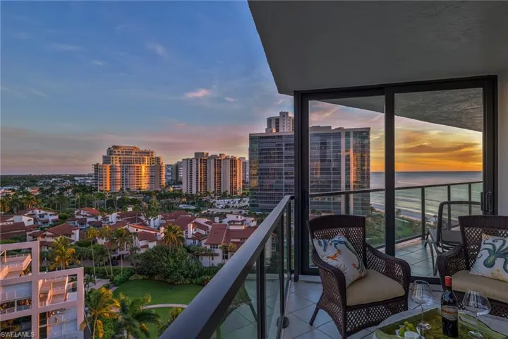 Balcony at dusk with a view of city and Gulf