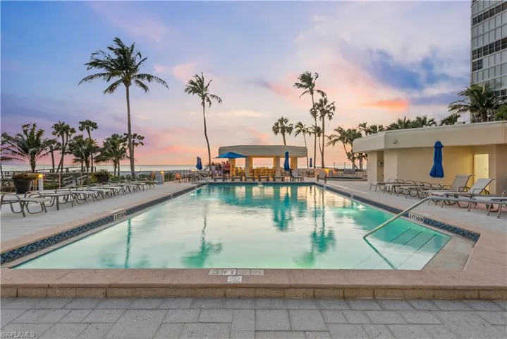 Community pool deck at sunset