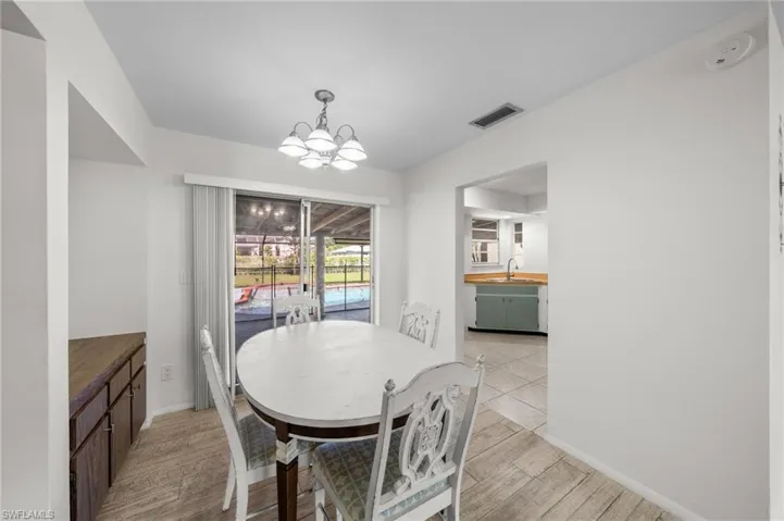 Dining area featuring light wood-style flooring and a chandelier