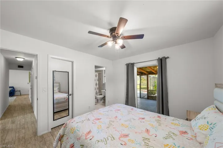 Bedroom featuring a closet, light wood-style flooring, and a ceiling fan