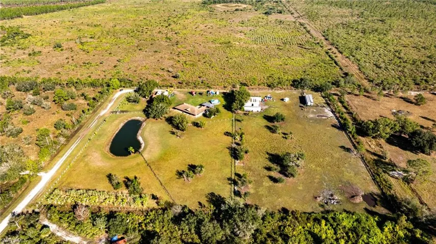 Aerial view of sparsely populated area with rows of crops