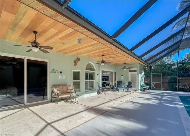 Expansive 41' covered lanai with faux wood painted ceiling offering plenty of room to entertain your family and friends or Corn Hole out of the rain!