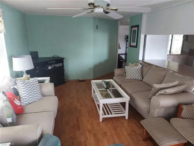 Living room featuring hardwood / wood-style floors and ceiling fan