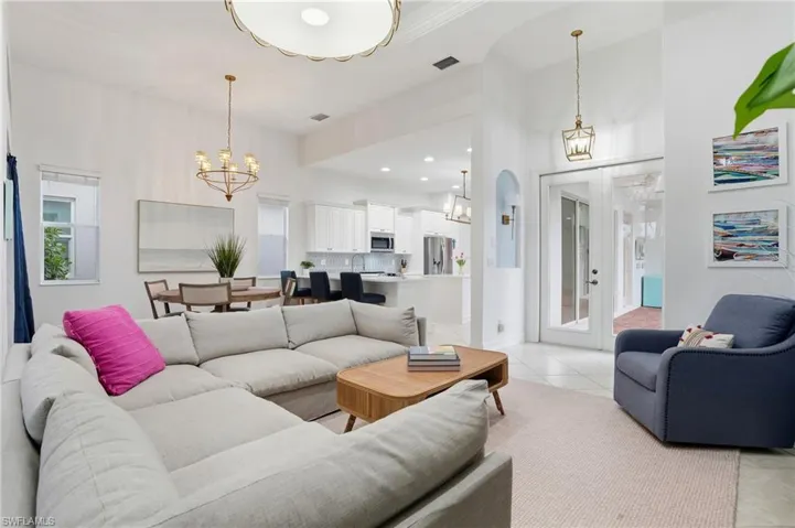 Living room featuring light tile patterned floors, recessed lighting, and a chandelier