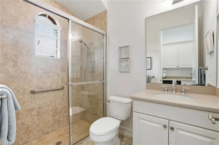 Full bath featuring a shower stall and vanity